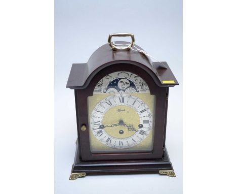 A modern Hermel mantel clock, the brass dial with silvered roman chapter ring un moon phase, fitted a chiming movement, in st