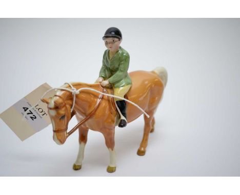 A Beswick model of a young boy hunter in green coat, on Palomino Horse, 14cms high.