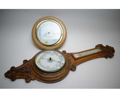 An aneroid barometer with thermometer, in carved oak banjo-style case, 90cms high; together with a modern German barometer, i