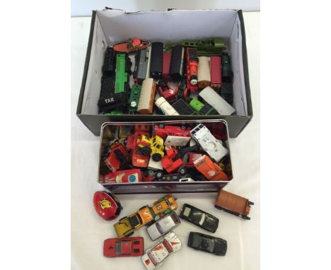 A box of Thomas the Tank Engine trains together with a tin of mixed diecast cars.