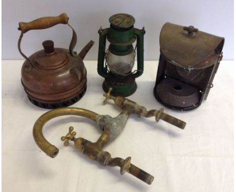 Mixed metalware items comprising brass taps, copper kettle, tilley lamp, and brass lamp.