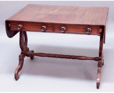 GEORGE IV MAHOGANY SOFA TABLE, the rounded rectangular top with ebony line inlay above two true and two false drawers with tu