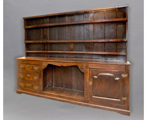 GEORGE III OAK DRESSER, the boarded three shelf plate rack with iron hooks on a base with a central 'kennel' flanked by three