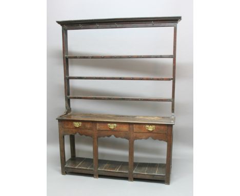 OAK DRESSER, essentially 18th century, the three shelf plate rack ona base with three drawers and triple arch open pot shelf,