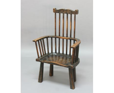 PRIMATIVE COMB BACK WINDSOR CHAIR, possibly late 18th century, ash and elm, with shaped top rail, solid seat and tapering, sp