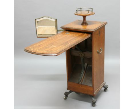 TROTTER'S PATENT CABINET, the oak body with chequered inlay, a central revolving tray above a fall front cabinet, adjustable 