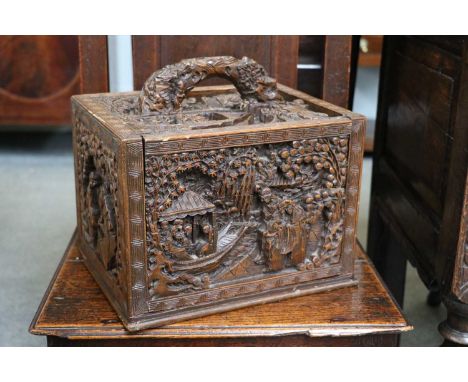 An Ornately Carved Chinese Hardwood Mahjong Box, containing mother of pearl and bone counters and plastic tilesCase with sect