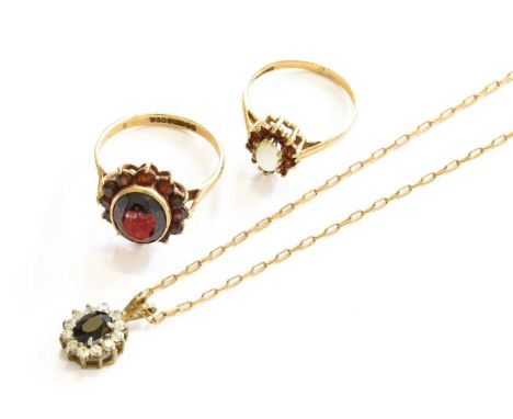 A 9 Carat Gold Garnet Cluster Ring, finger size P; A 9 Carat Gold Opal and Garnet Cluster Ring, finger size L; and A Paste Cl