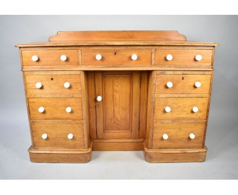 A Victorian Galleried Kneehole Pine Desk with Centre Drawer over Central Cupboard and Four Drawers Either Side, All with Whit