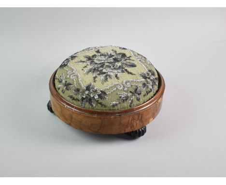 A Victorian Beadwork Circular Footstool with Ceramic Bun Feet, 29cms Diameter
