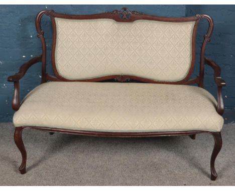 A Victorian carved mahogany upholstered parlour sofa. (93cm x 125cm x 54cm)  