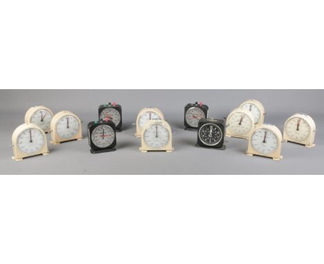 A collection of timing clocks and stopwatches, to include enamel and Smiths examples.  