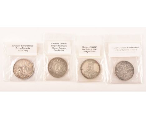 A group of four Chinese silver coins including a China Xuan Tong, Year 3 (1911) 1 dollar Coin Dragon, a Chinese Tibetan Guang