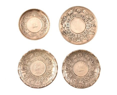 A group of four Chinese silver dishes, comprising a pair of silver dishes decorated with the Chinese Zodiac, inset with coins