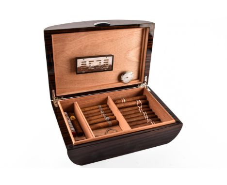 A collection of cigars contained in a Dalmore Highland single malt scotch whiskey case converted humidor, including eleven Ro