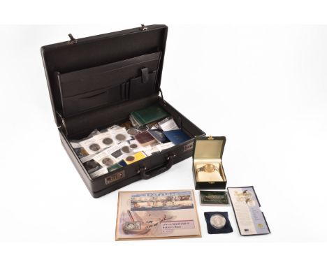 A collection of silver and base metal coins, including a Chinese Year of the Dragon silver coin, a Life on Board Ship in Nels
