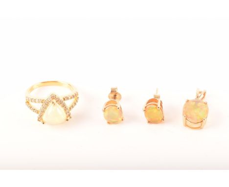 A 9ct yellow gold stud earrings, each set with a oval opal, together with a 9ct yellow gold pendant set with a marge oval opa
