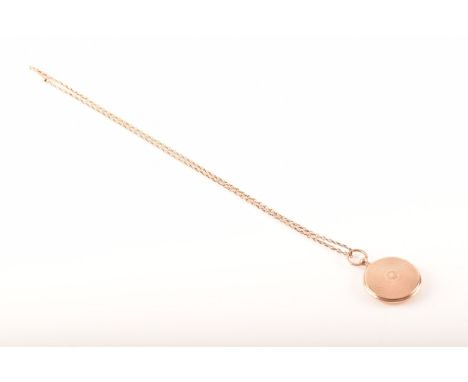 A circular locket, opening to reveal a miniature portrait and a braided locket of hair, suspended from a 9ct rose gold chain,