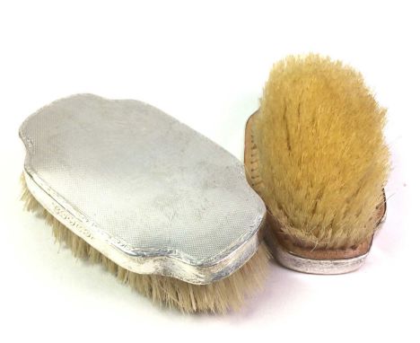 TWO SILVER BACKED HAIR BRUSHES, each top of engine turned form, with engraved initials