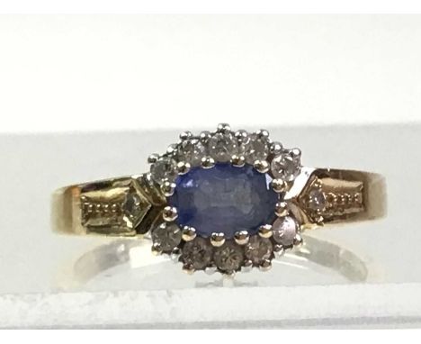 GEM SET AND DIAMOND RING, set with an oval blue stone within a halo of small diamonds, in nine carat gold, size PQty: 2.9gOve