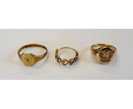 A 9ct gold oval signet ring, crest engraved, London 1952, a 9ct gold plain signet ring, Birmingham 1932 and a gold ring, pier