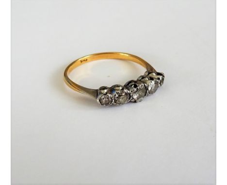 A gold and diamond set five stone ring, mounted with a row of graduated cushion shaped diamonds, the marks rubbed, ring size 