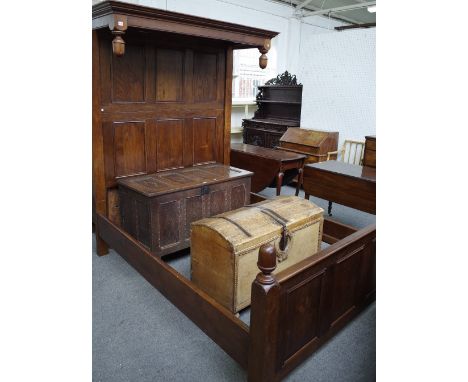 A 17th century style oak half tester bed, with panel head and foot board and acorn finials, 175cm wide x 213cm long x 214cm h