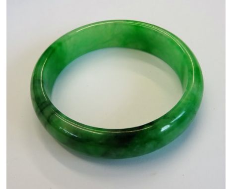 A jadeite jade bangle, the exterior domed, the interior flat, size 7.03 mm deep x 15.40mm wide and 57 mm inside diameter, wei
