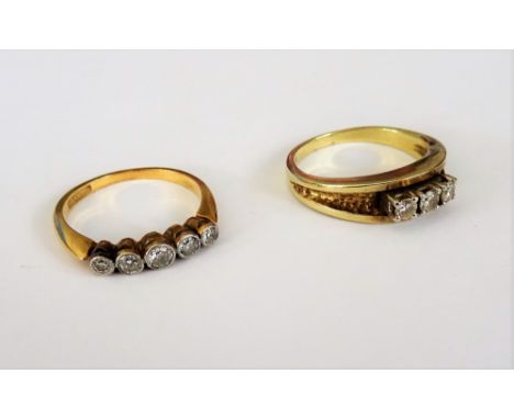 A gold and platinum, diamond set five stone ring, collet set with a row of cushion shaped diamonds, graduating in size to the