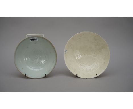 A Chinese qingbai glazed bowl, Song dynasty, the interior carved with a peony beneath a light blue transparent glaze, 17cm. d