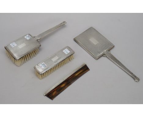 A lady's silver mounted four piece composite dressing set, comprising; a hand mirror, a hair brush, a clothes brush and a com