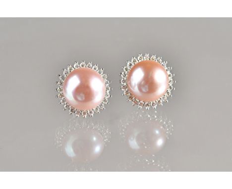 A pair of white gold, diamond and culutred pearl earstuds, each mounted with a large cultured pearl to the centre, within a s