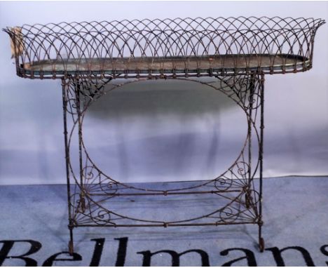An early 20th century wirework oval planter, 105cm wide x 76cm high, and a pair of early 20th century black painted metal fau