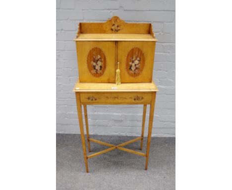 A late 19th century satinwood polychrome floral painted side cabinet, the shelf back over a pair of doors and drawers on tape