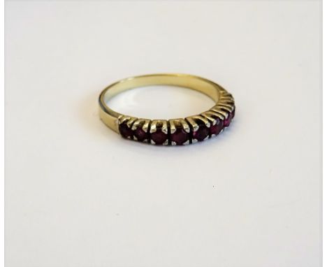 A gold and ruby set nine stone half hoop ring, mounted with a row of circular cut rubies, detailed 585, ring size O and a hal