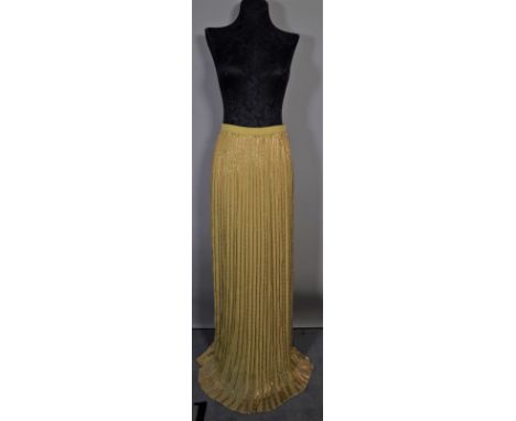 Christian Dior Haute Couture, a yellow and gold beaded silk evening skirt and a brown pin striped wide leg trouser suit with 