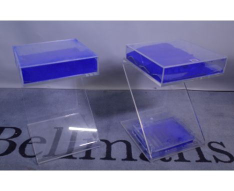 A pair of 20th century perspex side tables of 'Z' form filled with blue powder, 30cm wide x 46cm high, (one a.f.).  Provenanc