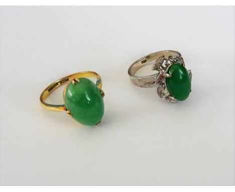 A gold ring, mounted with an oval cabochon jade, detailed RANZAN 9 CT, ring size N and a half and another caobohcon green gem