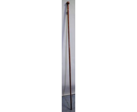 A South African hardwood long stick, with spherical pommel over a cylindrical shaft, 153cm.