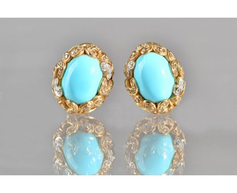 A pair of two colour gold, turquoise and diamond earclips, each mounted with an oval turquoise to the centre, within a serpen