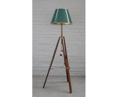 A mahogany and brass mounted tripod standard lamp with adjustable legs and green shade and a 17th century style carved walnut