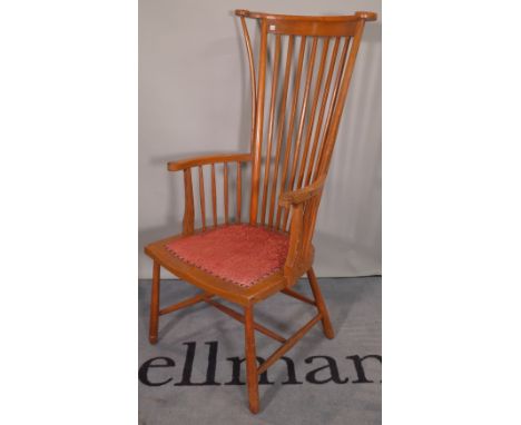 An early 20th century beech stick back armchair on tapering supports. 