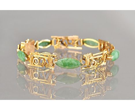 A gold and jade bracelet, the links in a rectangular openwork abstract design, with a textured finish, mounted with five marq