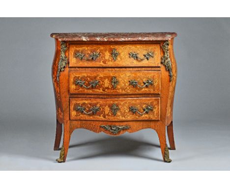 A Louis XV style commode, the serpentine marble top over a gilt metal mounted, floral marquetry inlaid Kingwood three drawer 