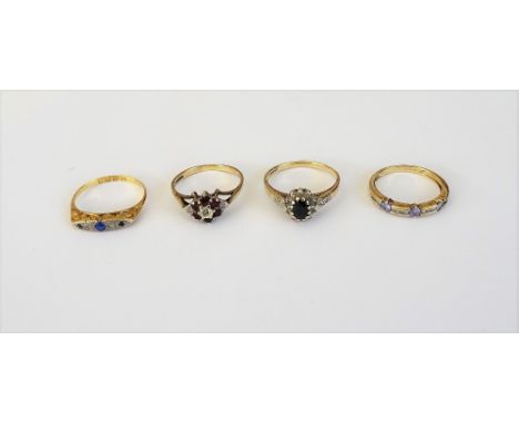 An 18ct gold, diamond and blue gem set ring, Chester 1927, a 9ct gold, sapphire and diamond set oval cluster ring, a 9ct gold