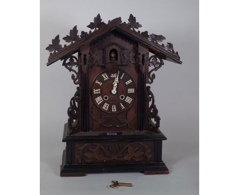 A late 19th century walnut cased cuckoo clock (pendulum). 