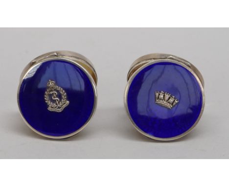 A lady's silver and enamelled circular hinge lidded powder compact, fitted with a mirror within, the lid applied with a badge