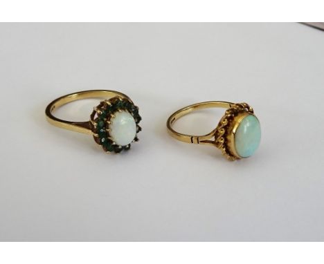 A 9ct gold, opal and emerald oval cluster ring, claw set with the oval opal in a surround of circular cut emeralds, ring size