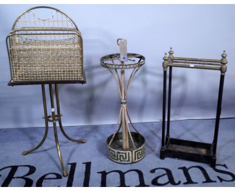 An Edwardian brass and ebonised four division magazine rack, 37cm wide x 86cm high, a circular tôle peinte umbrella stand wit