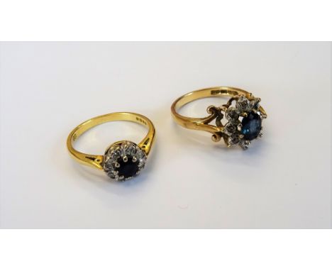 An 18ct gold, sapphire and diamond cluster ring, claw set with a circular cut sapphire, in a surround of eight circular cut d